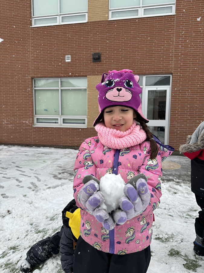 girl holding a snowball